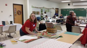 Vicky W., incoming Secretary, working on a Christmas table skirt